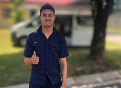 Jorden standing in front of a van giving the thumbs up gesture