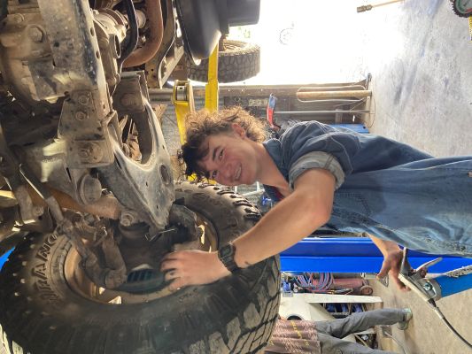 Elijah working underneath a car 